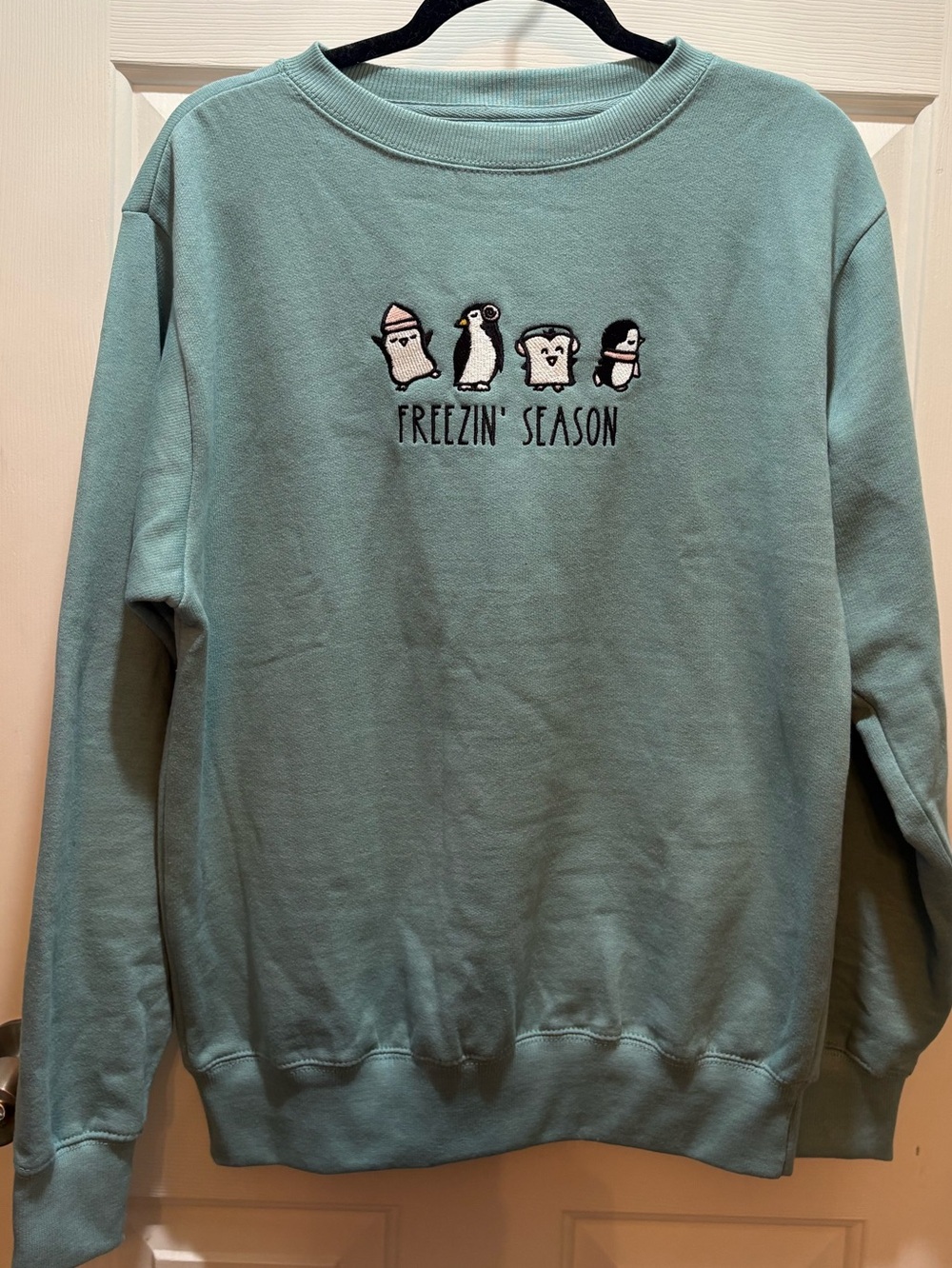 Love in Faith Medium Crewneck Sweatshirt in Light Teal with embroidered penguins
